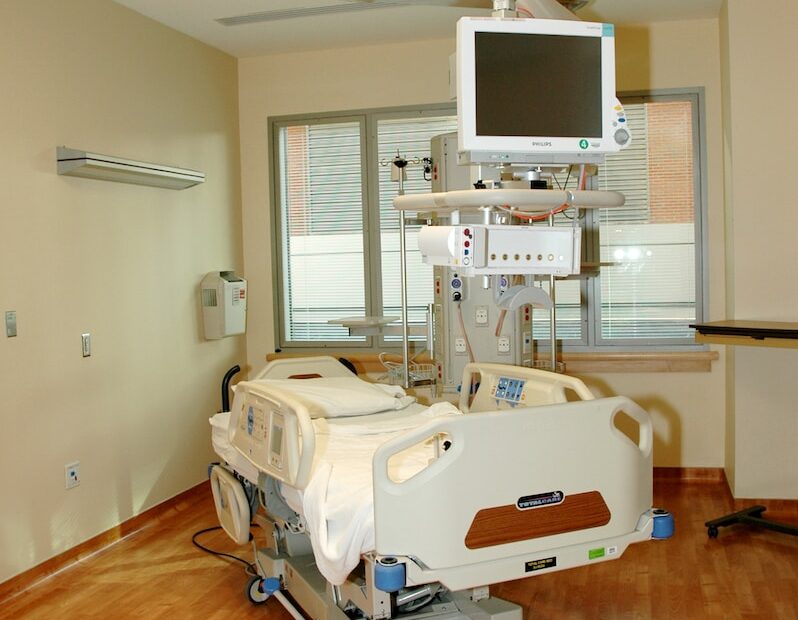 white hospital bed near white wall